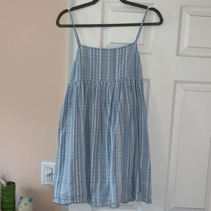 Light blue. It ties in the back.